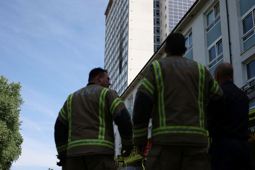 Firefighters work at the site of an apartment fire at Queensdale Crescent tower block, near the Grenfell Tower, in Shepherd's Bush, London, Britain June 21, 2022. REUTERS/Kevin Coombs