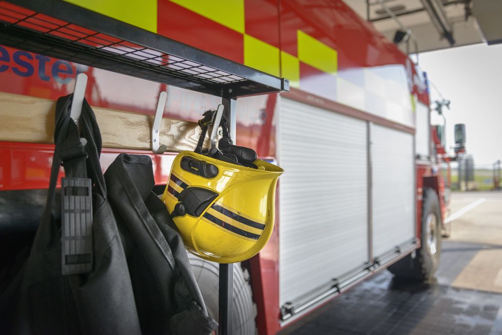 Firemans helmet hanging by fire engine in fire station