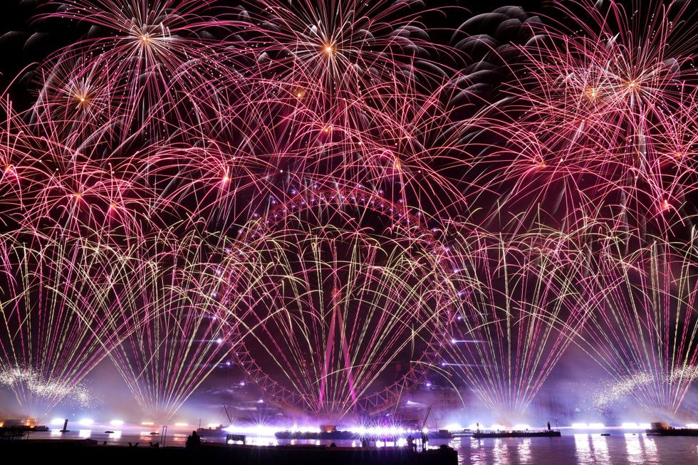 fireworks explode over the London Eye