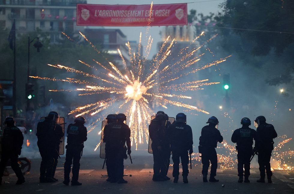 Fireworks were shot at riot police, who fired back tear gas in wild scenes in Paris