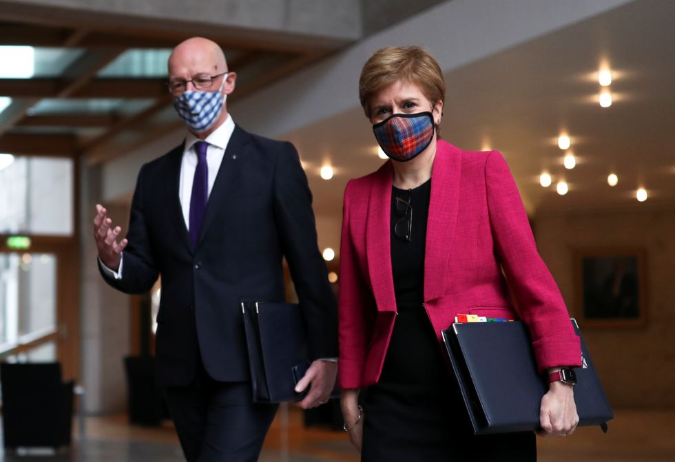 First Minister Nicola Sturgeon and Deputy First Minister John Swinney arrive for First Minister's Questions in the debating chamber of the Scottish Parliament in Edinburgh.