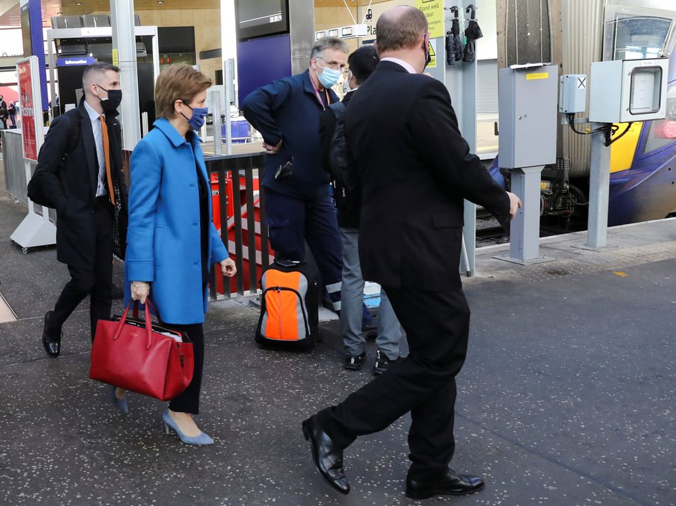 First Minister Nicola Sturgeon walks to board a train at the relaunch of Glasgow Queen Street station in Glasgow