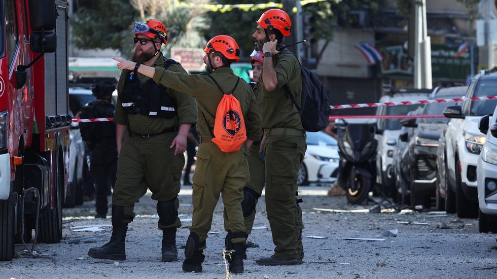 First responders gather at an impact site following Iran's strike on Israel, amid the Iran-Israel conflict, in Haifa, Israel