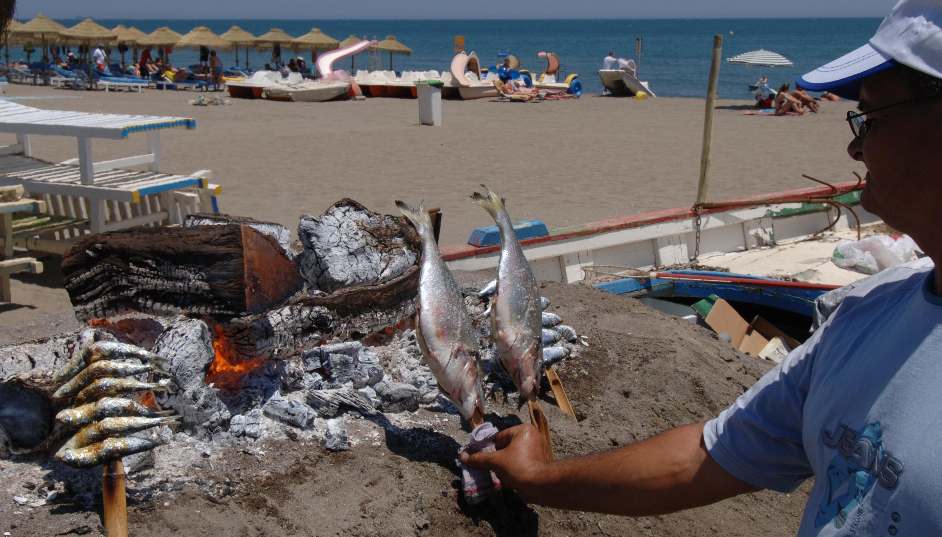 Fish being grilled on a Costa del Sol beach near Torremolinos. Fishermen in Malaga are currently on strike threatening the supply of fish for the summer season.
