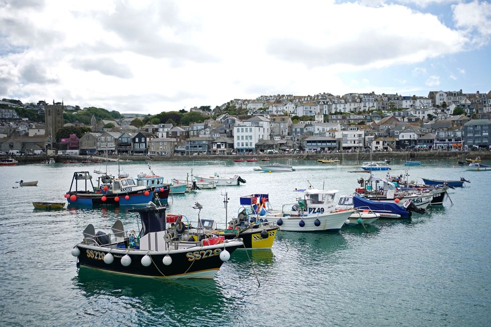 Fishing boats moored in St Ives harbour, in Cornwall, in the warm weather. Picture date: Monday June 7, 2021.