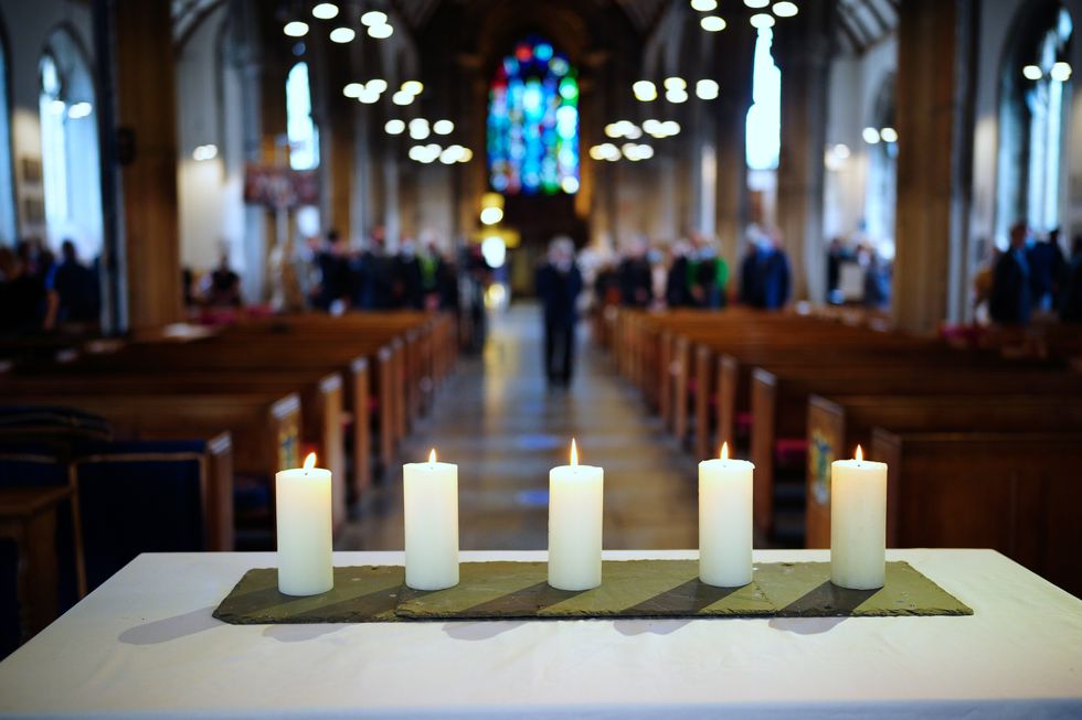 Five lit candles on the altar following a civic service to remember the five people who were killed by gunman Jake Davison in August.