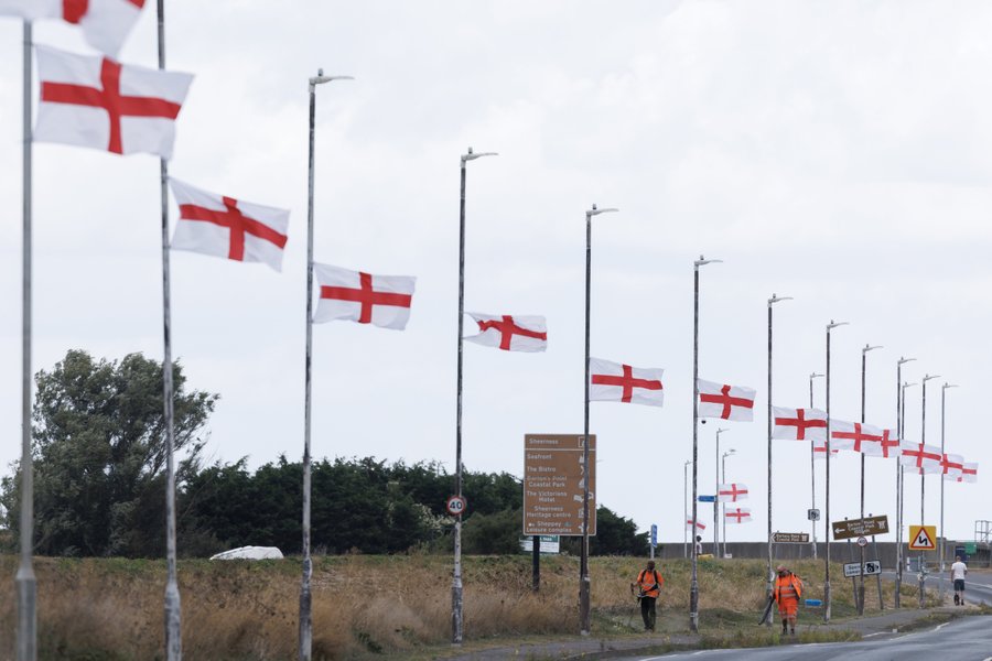 Flags on lampposts by a motorway