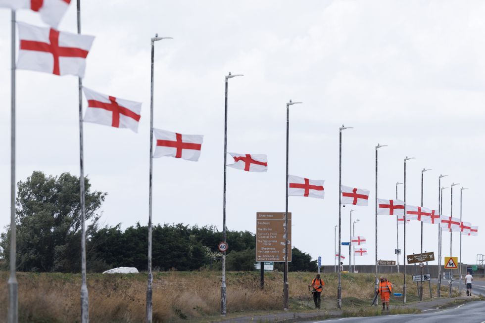 Flags on lampposts by a motorway