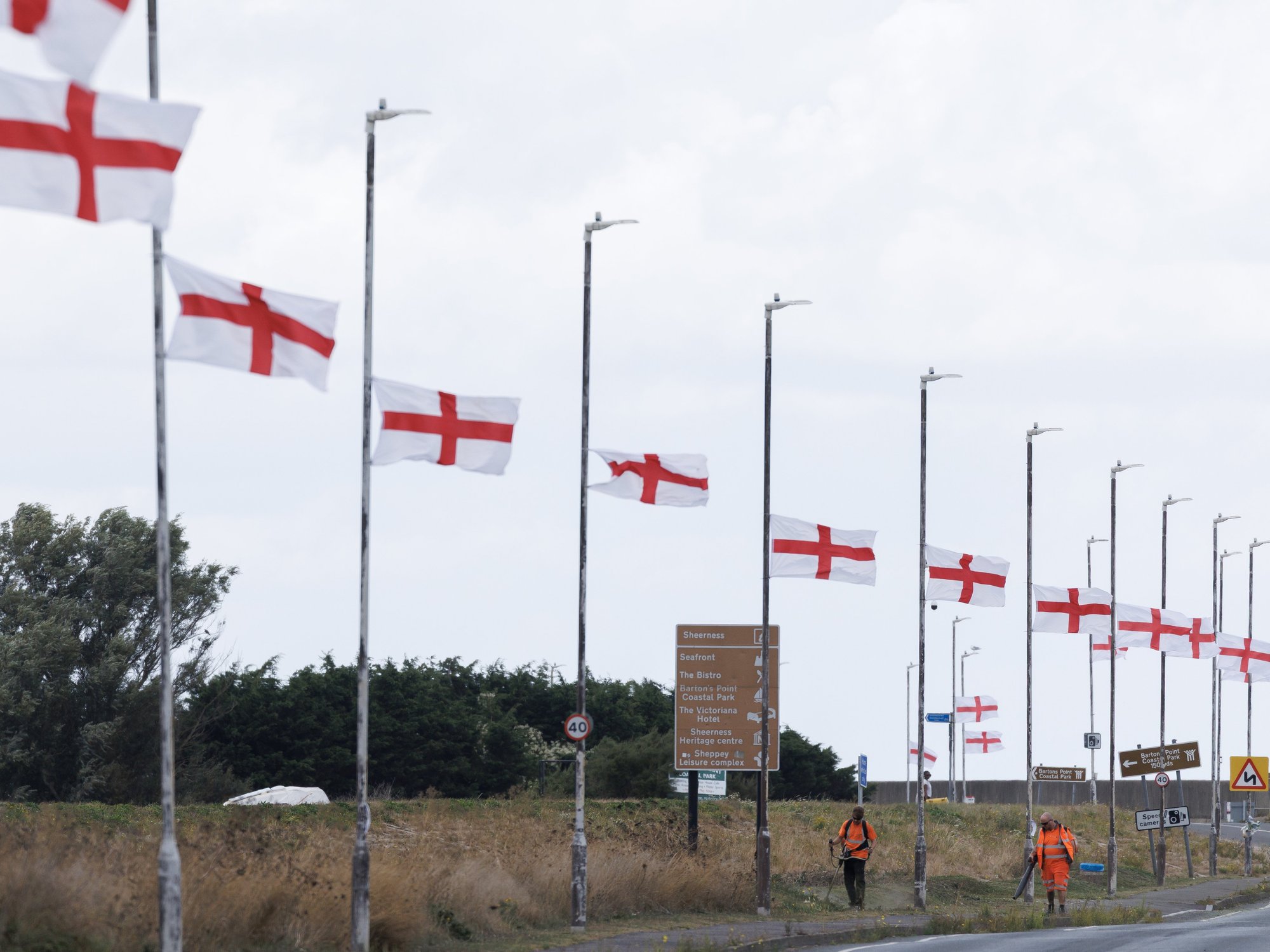 Flags on lampposts by the highway