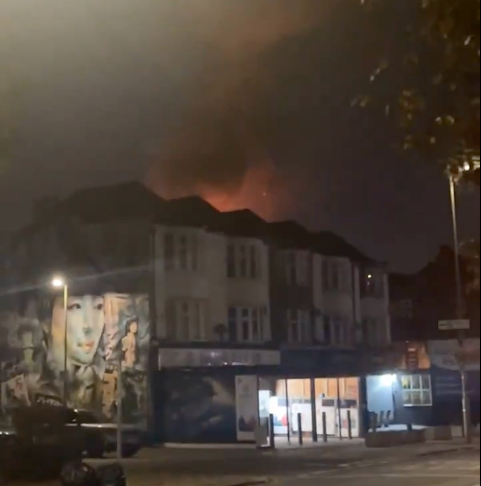 Flames above rooftops from fire in Penge