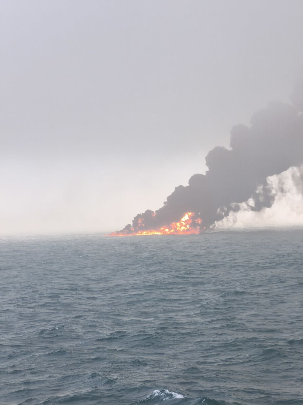Flames and smoke rise from a collision between oil tanker and a cargo ship off the northeastern coast of England