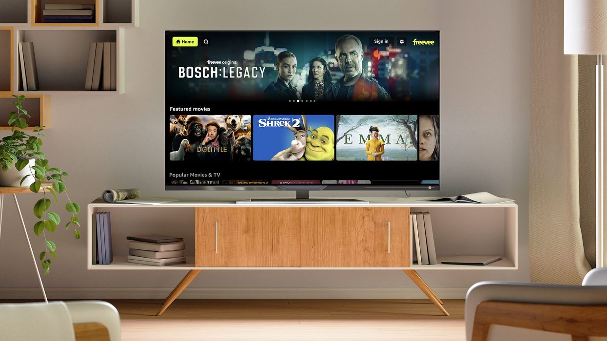 flatscreen television on a media unit with the freevee menu showing on-screen with different TV shows and films