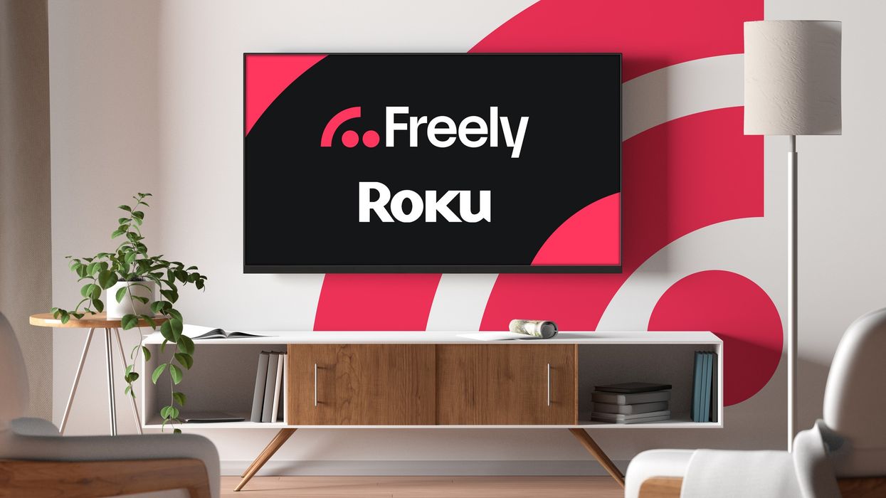 flatscreen television pictured mounted on a wall with the freely logo in the background and the ROKU logo on-screen