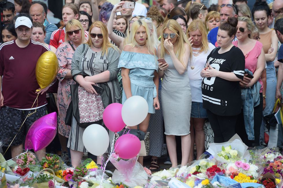 Floral tributes after a minute's silence in St Ann's Square, Manchester, to remember the victims of the terror attack in the city.
