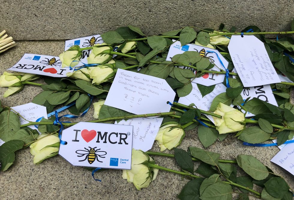 Floral tributes left in St Ann's Square in Manchester city centre to remember the second anniversary of the Manchester Arena terror attack where twenty-two people were murdered when suicide bomber Salman Abedi detonated a device in the foyer at the end of Ariana Grande show.