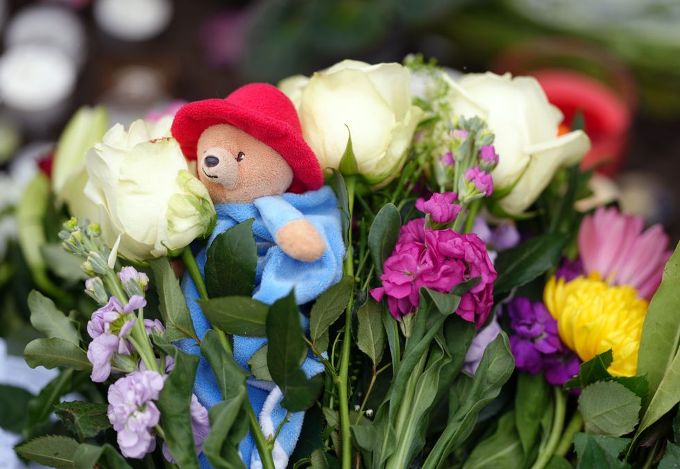 Flowers and a Paddington Bear teddy are laid outside of Windsor Castle, Berkshire, following the death of Queen Elizabeth II on Thursday. Picture date: Friday September 9, 2022.