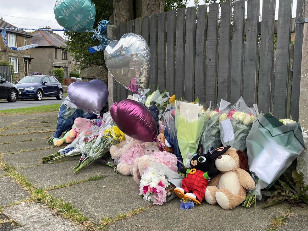 Flowers and tributes near the scene of a fatal house fire in Bradford, which took the lives of a mother and her three children