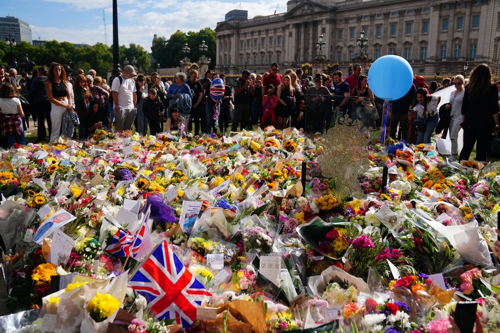 Flowers and tributes outside Buckingham Palace, London, following the death of Queen Elizabeth II on Thursday. Picture date: Saturday September 10, 2022.