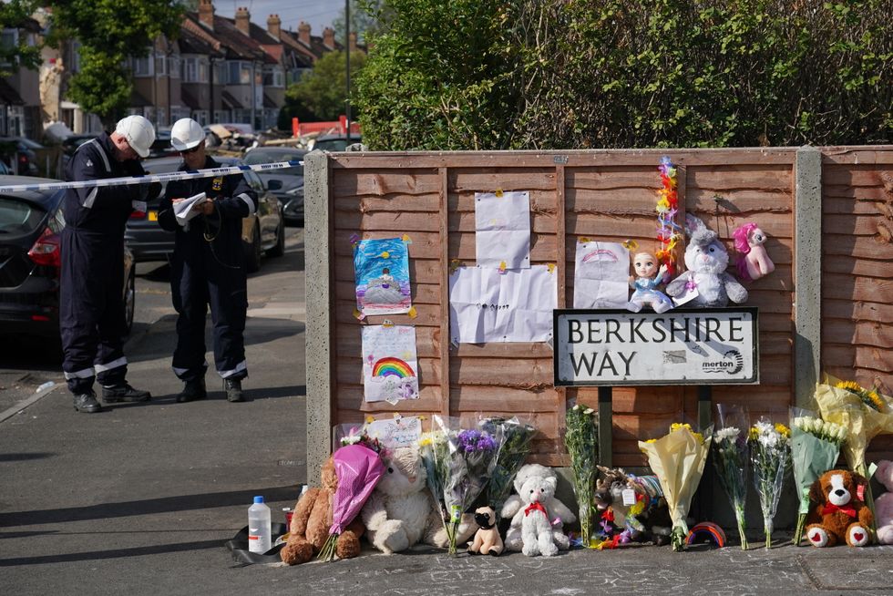Flowers are laid near to the scene in Galpin's Road in Thornton Heath, south London. The London Ambulance Service has confirmed a child has died and three people are in hospital after the terraced home collapsed following an explosion and fire on Monday. Picture date: Tuesday August 9, 2022.
