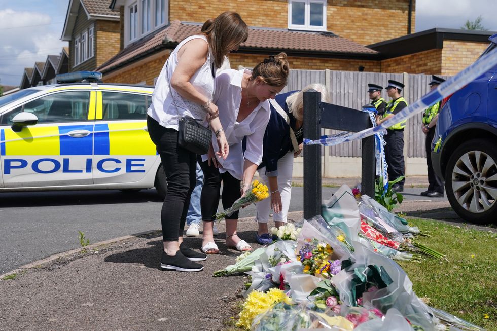 Flowers given outside John Hunt's family home after the murder of his wife and two daughers