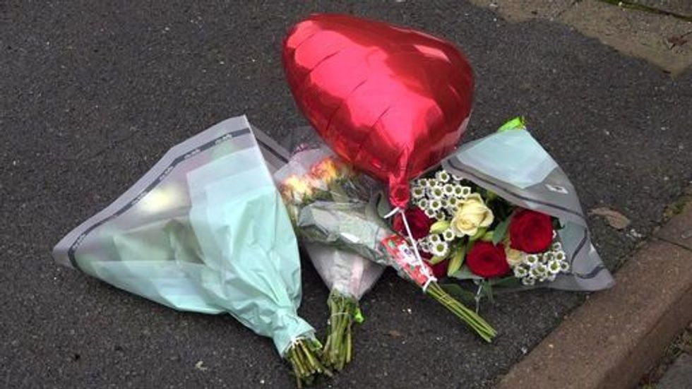 Flowers left at the scene of one of the murders on Titmuss Avenue