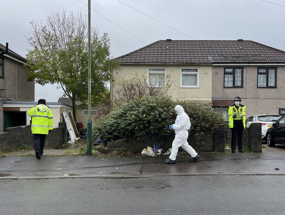 Flowers left outside the house in Pentwyn, Penyrheol, near Caerphilly where Jack Lis a 10-year-old boy was killed by a dog on Monday. A forensic crime scene investigator is seen outside the house. The dog was destroyed by firearms officers and no other animals were involved in the attack.