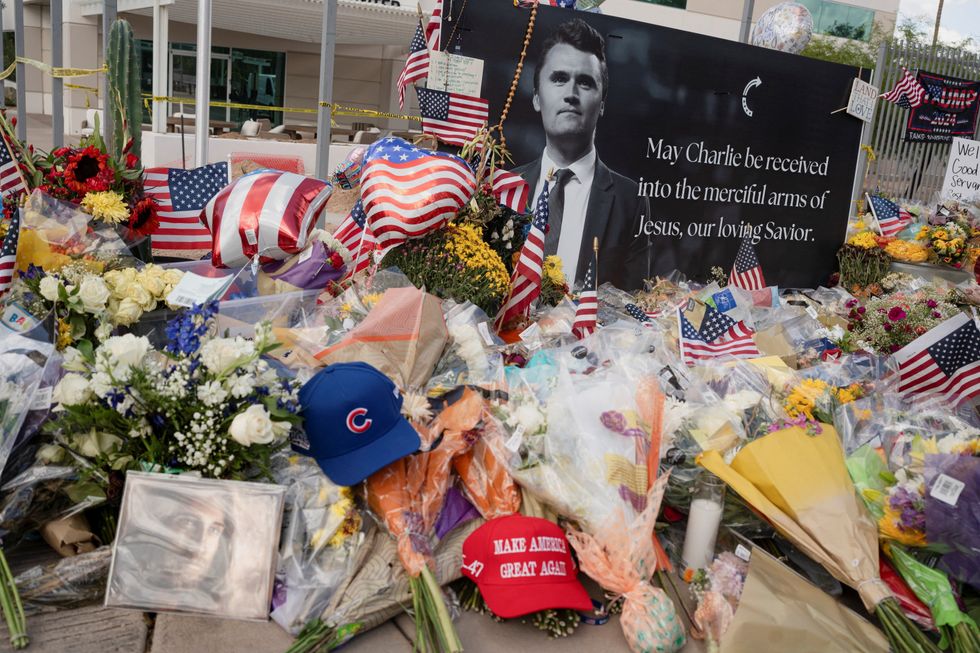 Flowers, photos and other items lie at a memorial to Charlie Kirk at the Turning Point USA headquarters in Phoenix, Arizona