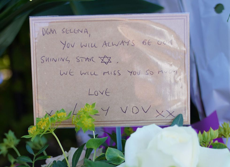 Flowers with a message saying: "Dear Selena, you will always be our shining star. We will miss you so much."