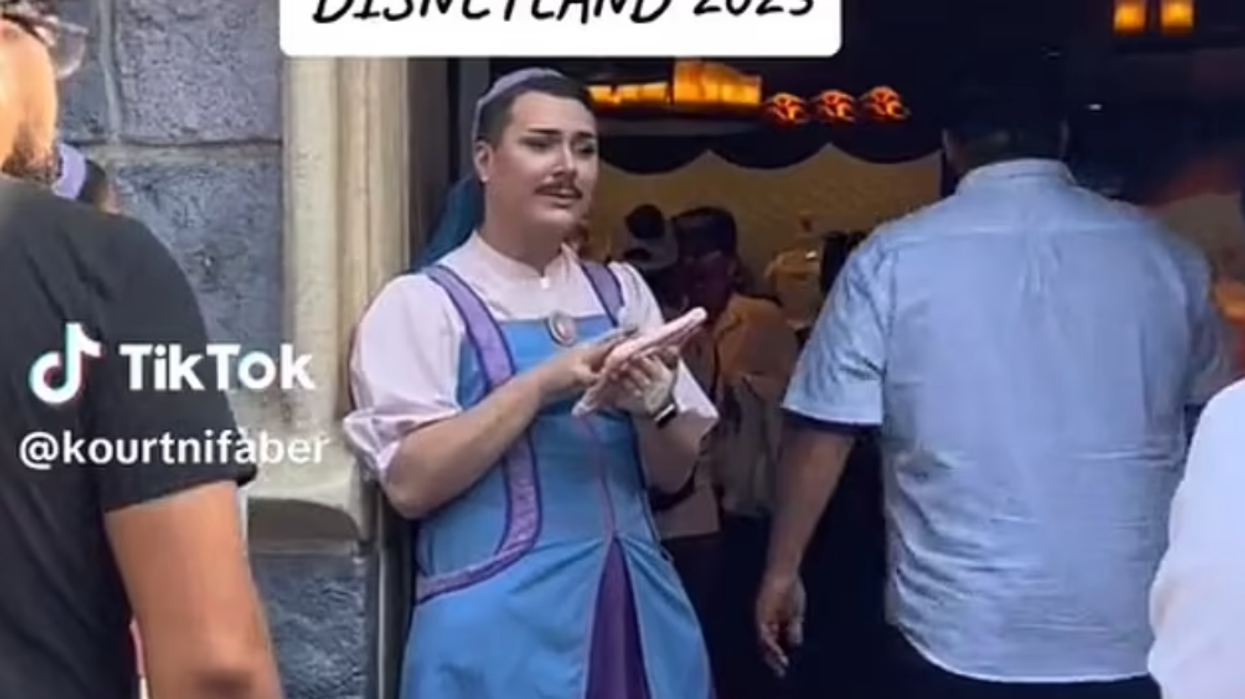Footage shows the worker wearing a blue and purple dress, welcoming a young girl at the Bibbidi Bobbidi Boutique in Anaheim, California