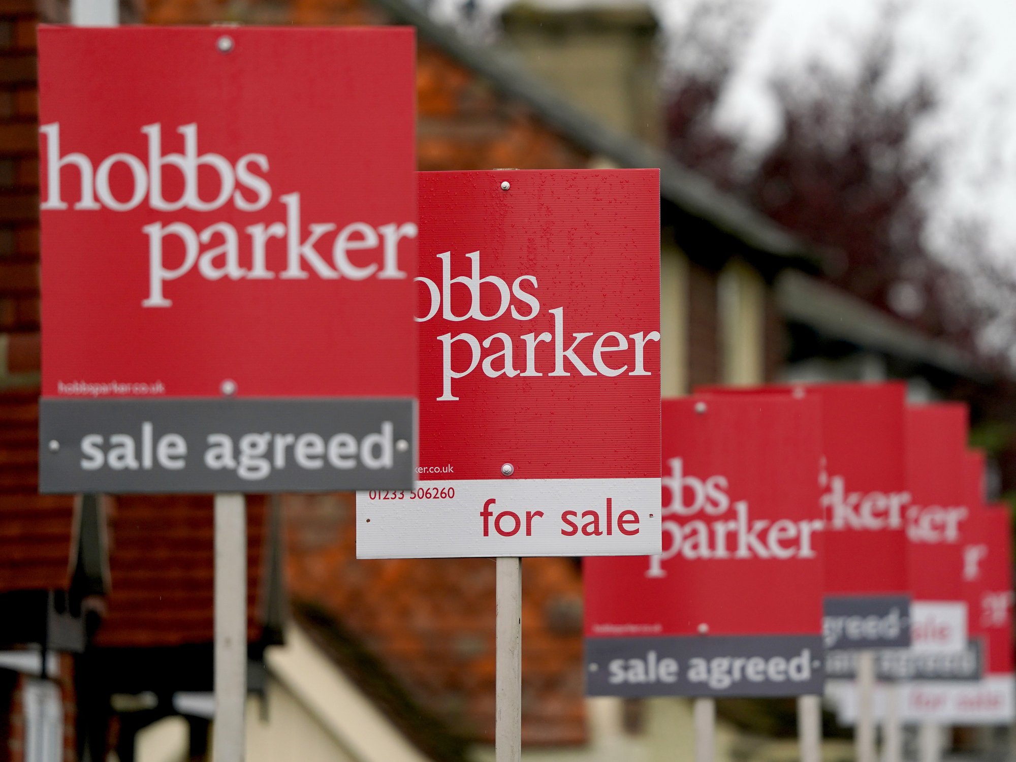 For sale and sale agreed signs in a row