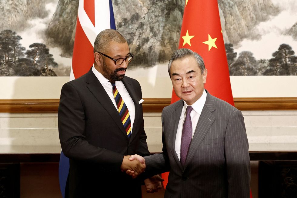 Foreign Secretary James Cleverly and Chinese Foreign Minister Wang Yi shake hands before a meeting at the Diaoyutai State Guesthouse in Beijing