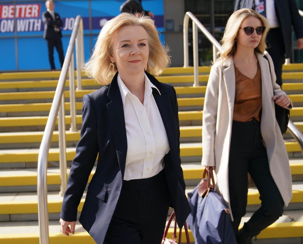 Foreign Secretary Liz Truss walks to a fringe event during the Conservative Party Conference in Manchester.