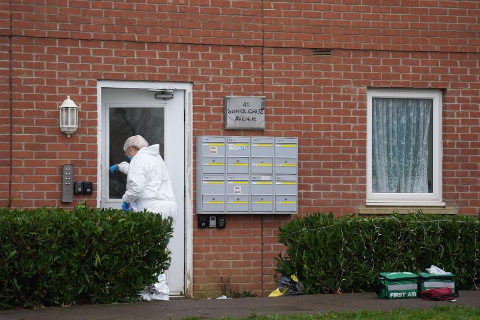 Forensic investigator entering property on Santa Cruz Avenue
