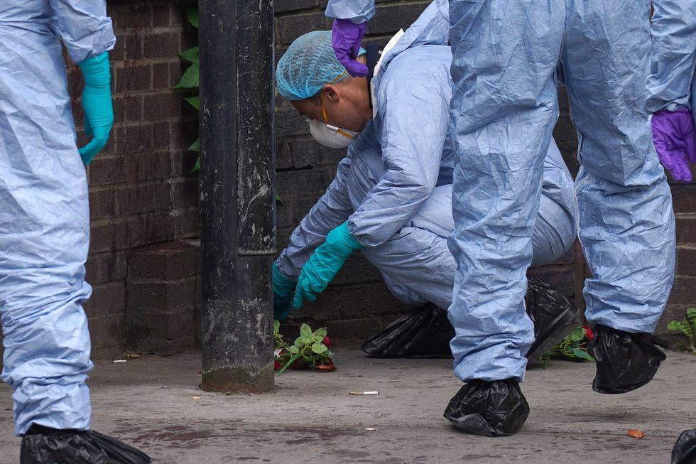 Forensic investigators at the scene near the Whitgift shopping centre in Croydon, south London after a 15-year-old girl was stabbed to death on Wednesday morning