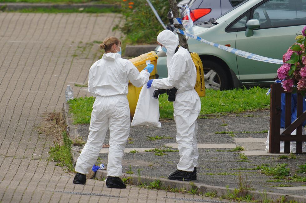 Forensic officers in Biddick Drive in the Keyham area of Plymouth where six people, including the offender, died of gunshot wounds in a firearms incident Thursday evening. Picture date: Friday August 13, 2021.