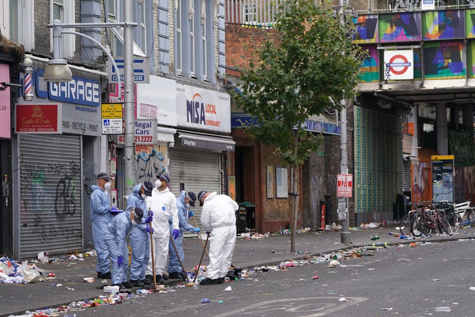 Forensics officers comb the scene in Ladbroke Grove, west London, where 21-year-old Takayo Nembhard, a rapper from Bristol, has died after being stabbed on the final day of the Notting Hill Carnival. Picture date: Tuesday August 30, 2022.