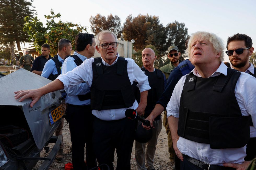 Former British Prime Minister Boris Johnson and former Australian Prime Minister Scott Morrison visit Kibbutz Kfar Aza following the October attack by Hamas gunmen from the Gaza Strip,