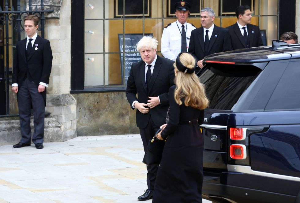 Former British Prime Minister Boris Johnson and his wife Carrie walk outside the Westminster Abbey, on the day of the state funeral and burial of Britain's Queen Elizabeth, in London, Britain, September 19, 2022. REUTERS/Hannah McKay/Pool