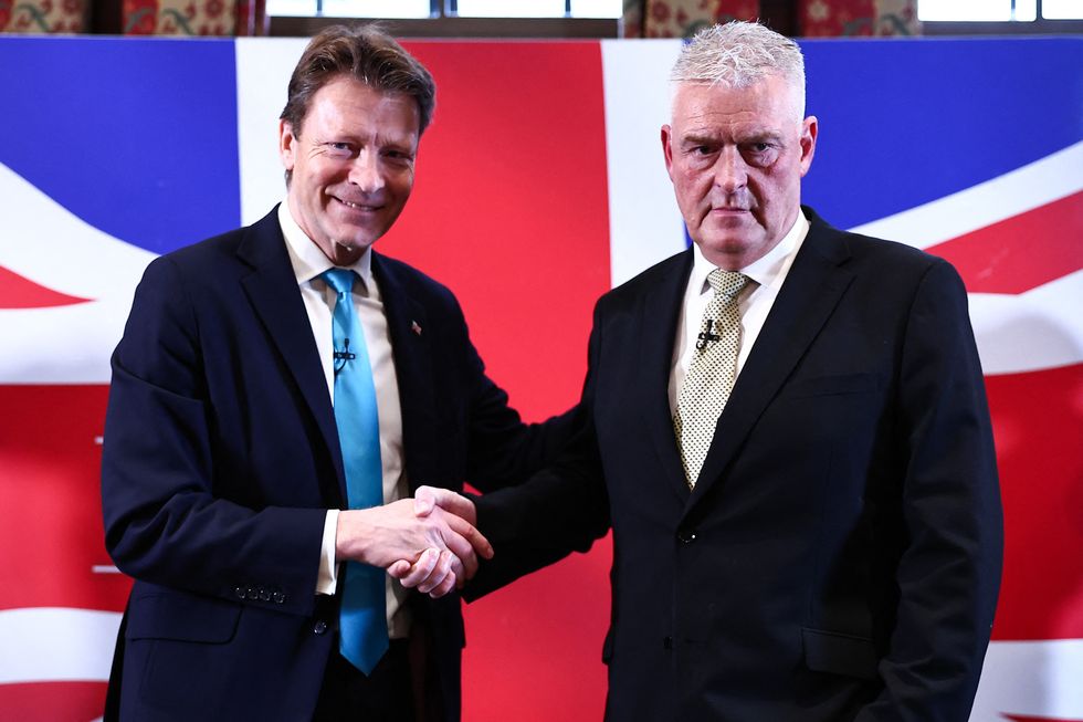 Former Conservative deputy chairman Lee Anderson (R) shakes hands with Leader of Reform UK party Richard Tice (L)