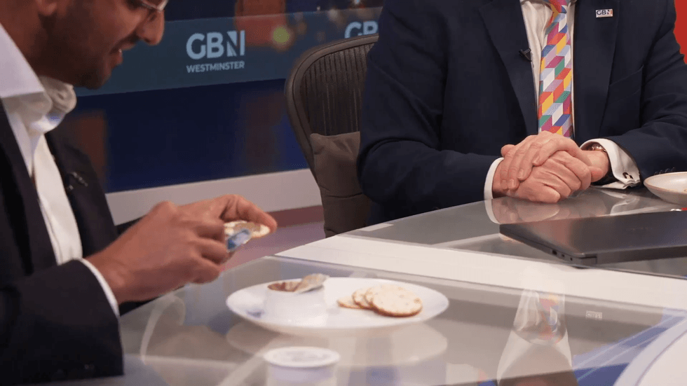 Former diplomat Ameer Kotecha prepares some Gentleman's Relish for Christopher Hope