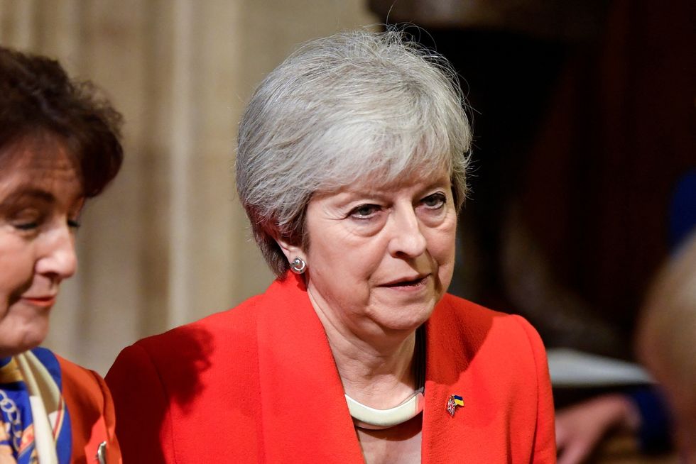 Former Prime Minister Theresa May walks through the Members' Lobby at the Palace of Westminster during the State Opening of Parliament in the House of Lords, London. Picture date: Tuesday May 10, 2022.