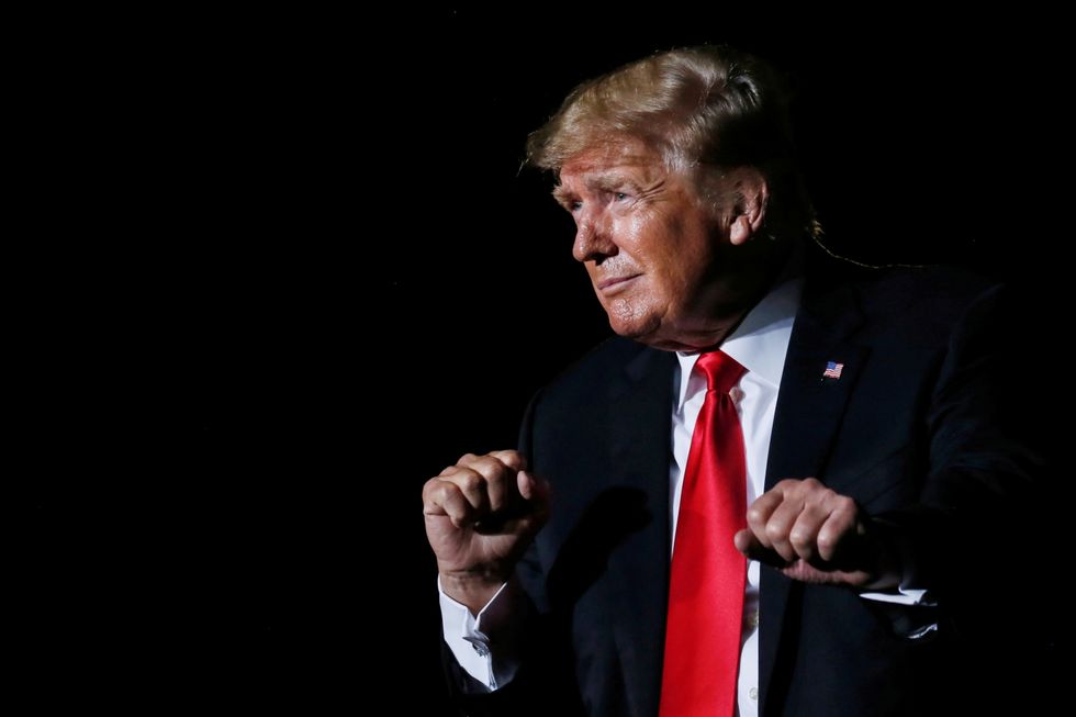 Former U.S. President Donald Trump reacts after his speech during a rally at the Iowa States Fairgrounds in Des Moines, Iowa, U.S.