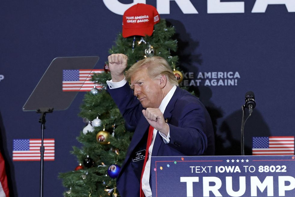 Former US President and 2024 presidential hopeful Donald Trump gestures during a campaign event in Waterloo, Iowa, on December 19, 2023