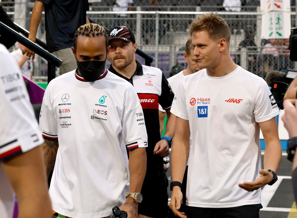 Formula One F1 - Saudi Arabia Grand Prix - Jeddah Corniche Circuit, Jeddah, Saudi Arabia - March 27, 2022 Mercedes' Lewis Hamilton and Haas' Mick Schumacher before the race REUTERS/Hamad I Mohammed