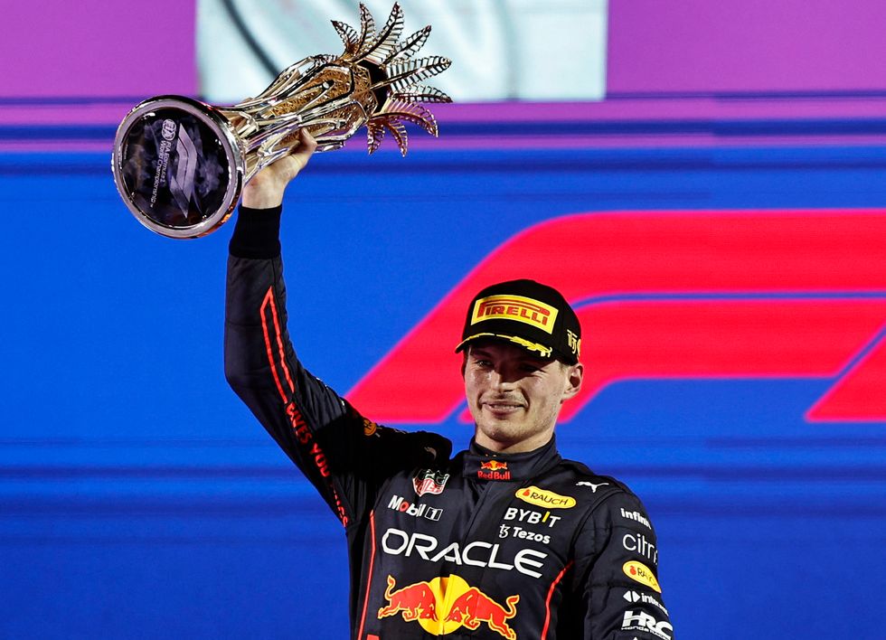 Formula One F1 - Saudi Arabia Grand Prix - Jeddah Corniche Circuit, Jeddah, Saudi Arabia - March 27, 2022 Red Bull's Max Verstappen celebrates on the podium with the trophy after winning the race REUTERS/Hamad I Mohammed