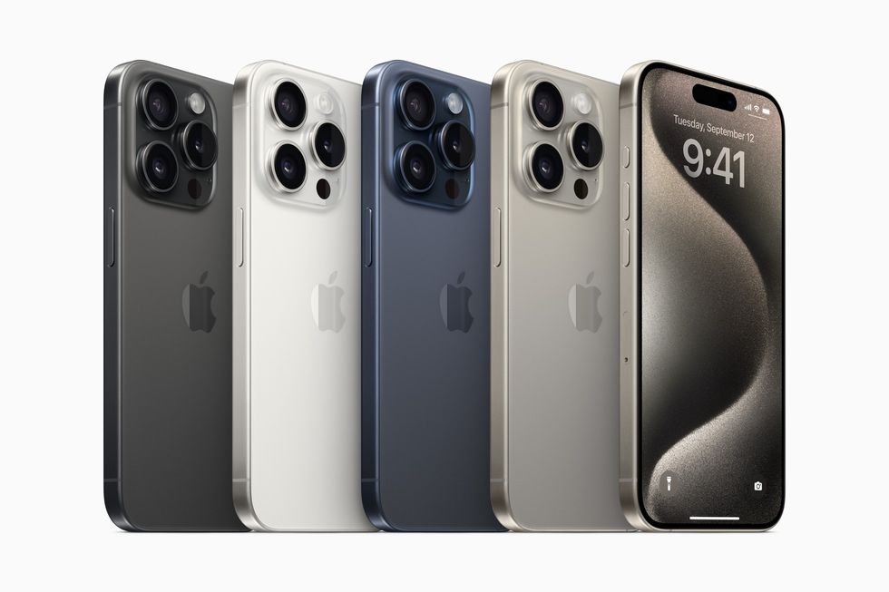 four iPhone 15 pro models standing side by side in Natural Titanium, Blue Titanium, White Titanium, and Black Titanium colours