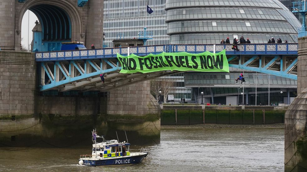 Four people accused of disrupting traffic during a protest on Tower Bridge in London have appeared in court.