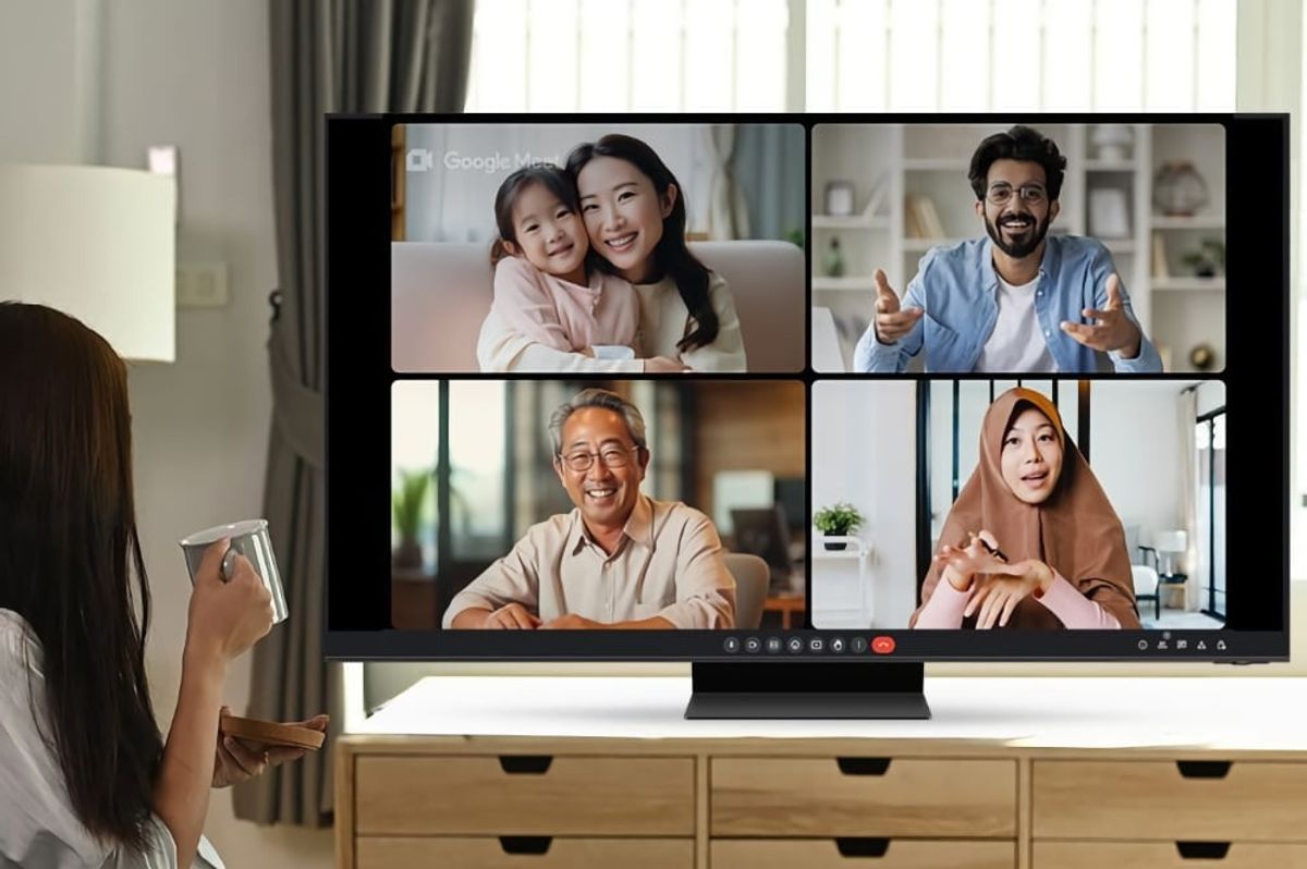 four people pictured on-screen on a google meet call on a samsung smart tv 