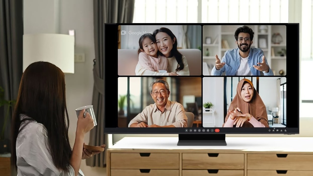 four people pictured on-screen on a google meet call on a samsung smart tv