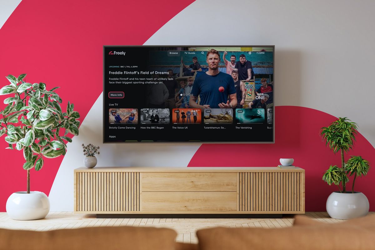 Freely logo pictured on a wall of a living room with a flatscreen smart tv mounted on the wall with the new freely features shown on-screen